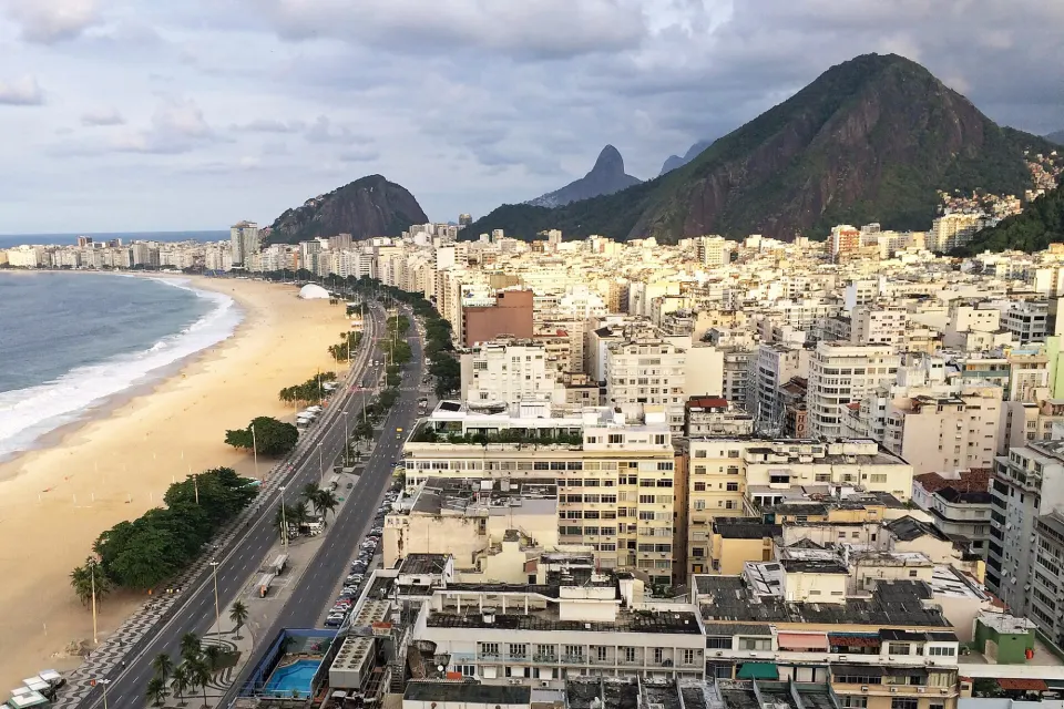 Elevated view of the beachfront avenue along Copacabana beach toward Leme and the mountains