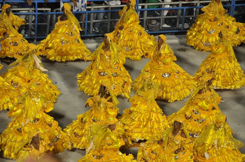 Baianas in golden hooped dresses dancing in the Sambadrome during the Rio Carnival parade