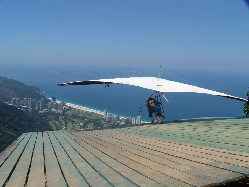 Tandem hang glider launching from the Pedra Bonita ramp above São Conrado beach