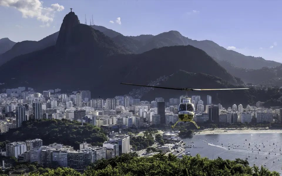 Helicopter flying over Botafogo Bay with Corcovado and Christ the Redeemer behind