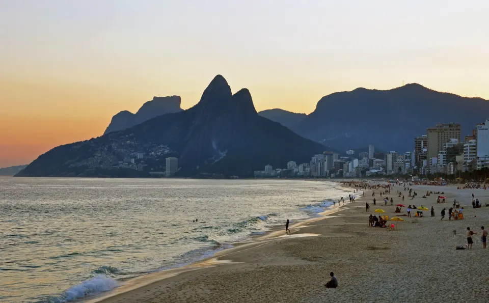 Ipanema beach at sunset with the Dois Irmãos peaks and Vidigal on the hillside