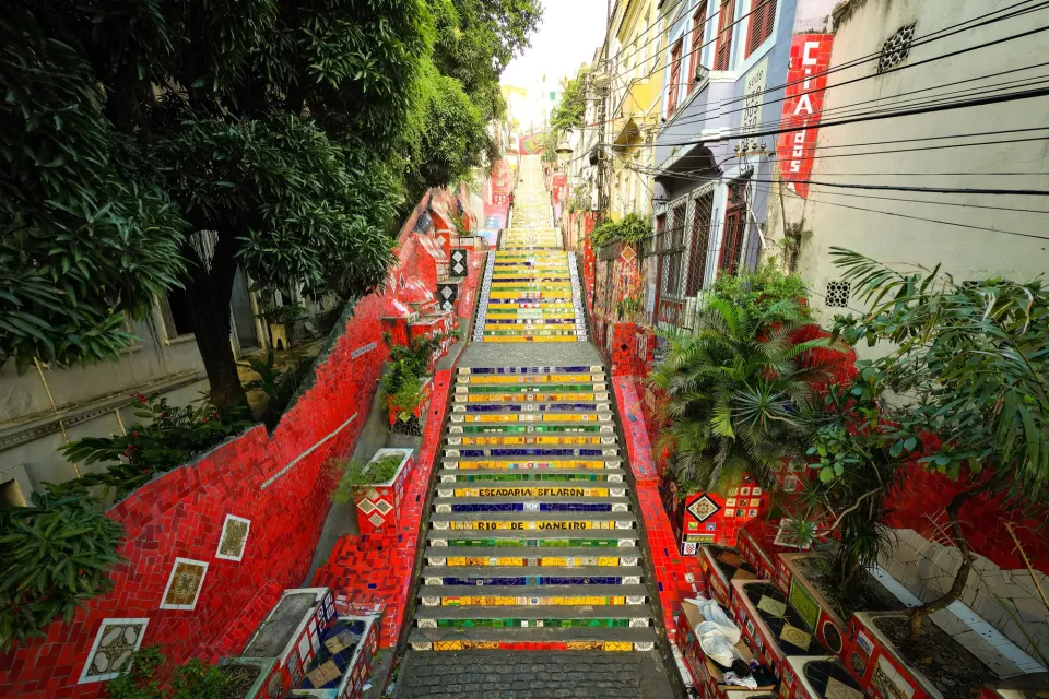Colorful tiled steps of Escadaria Selarón lined with red mosaic walls in Lapa